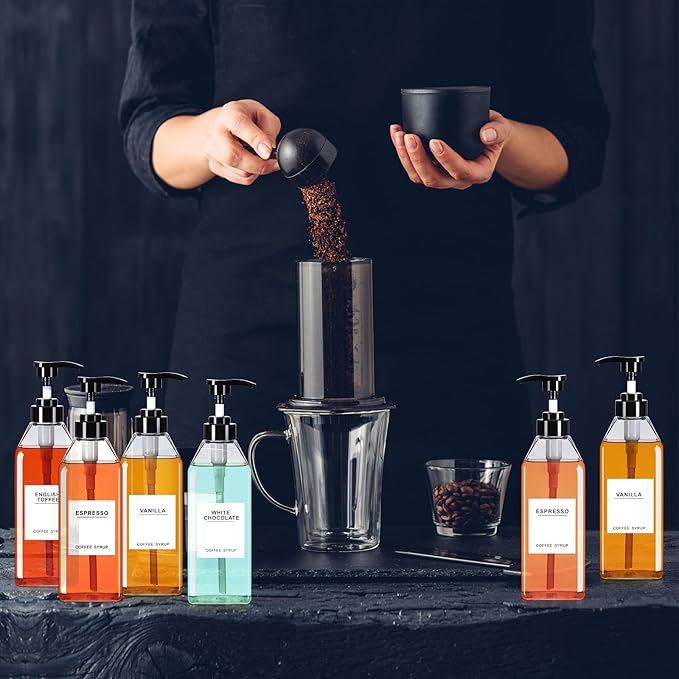 Nuogo 6 Pcs Coffee Syrup Dispenser Set 750ml, 500ml, 300ml, 150ml Pet Black Syrup Bottles with Pump Dispenser 27 Labels for Coffee Bar Kitchen Accessories Portable Travel(16.9 oz,Square)